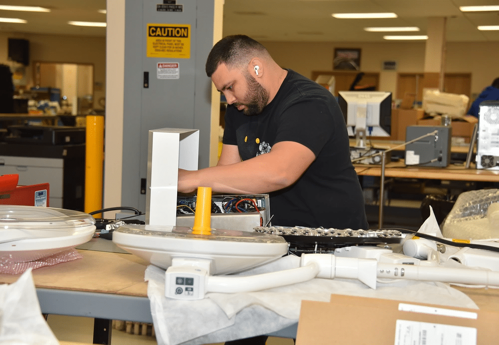 A biomedical equipment technician works on a medical device at the U.S. Army Medical Materiel Agency’s Medical Maintenance Operations Division at Hill Air Force Base, Utah. (Photo by C.J. Lovelace)